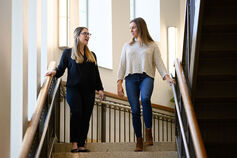 Two Kelley students walking down a stairway.